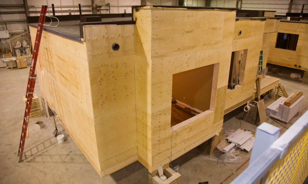 The construction of a wooden modular building being built in a warehouse