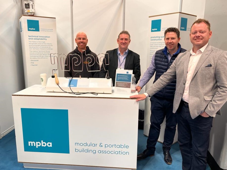 Wyre Solutions sales team standing with Mark McEvoy and Neil Stanley at the MPBA stand at UK Construction Week